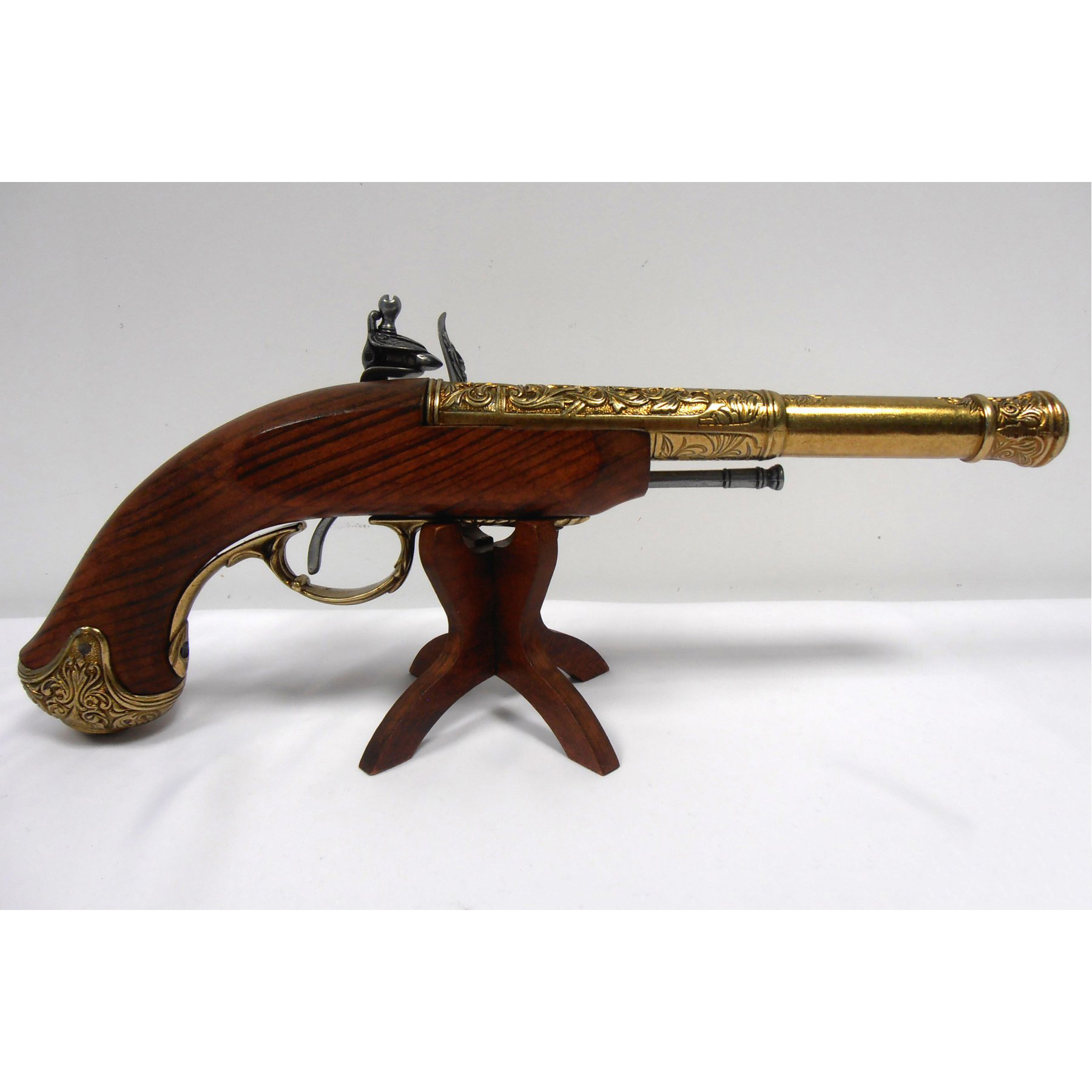 Pistola de chispa zurda de madera y metal acabado latón, India S. XVIII