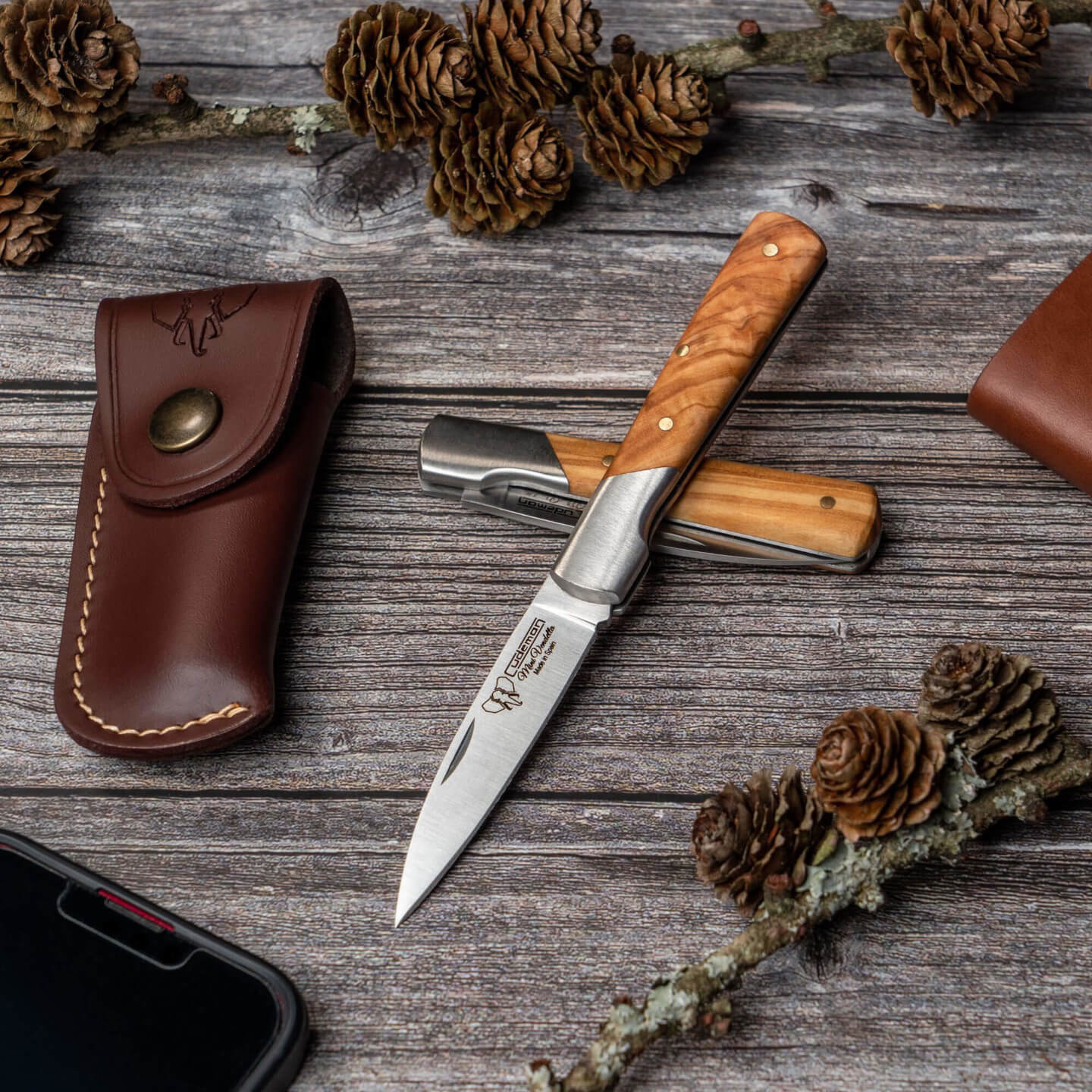 Canivete de bolso Cudeman com virola. Cabo em cetim azeitona. Inclui bainha em pele